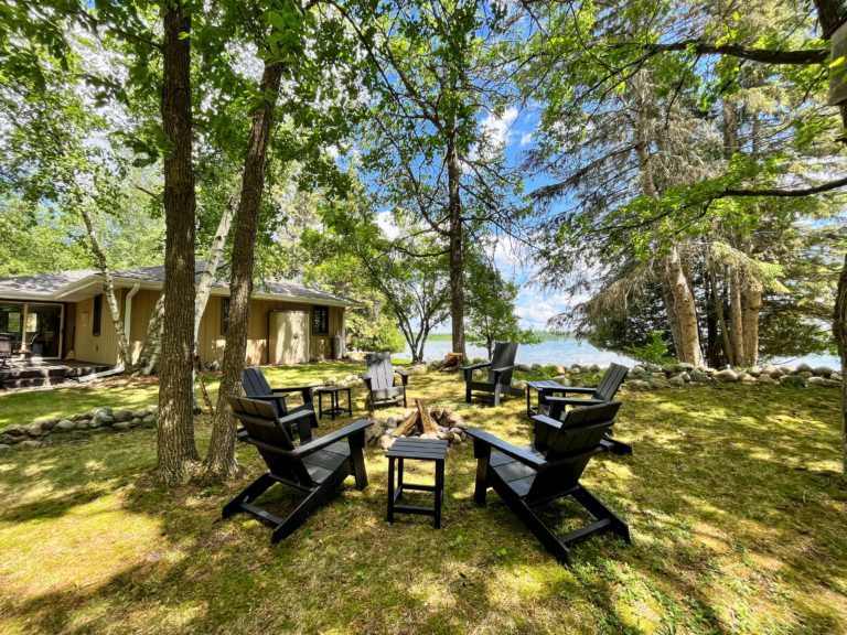 Fire pit with Adirondack chairs and tables