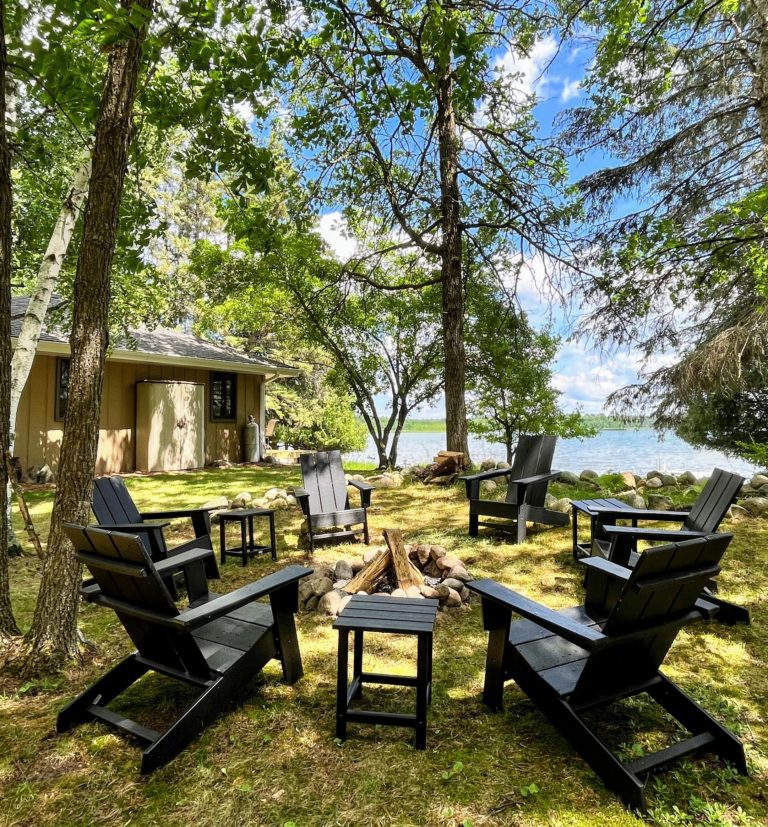 Fire pit with Adirondack chairs and tables