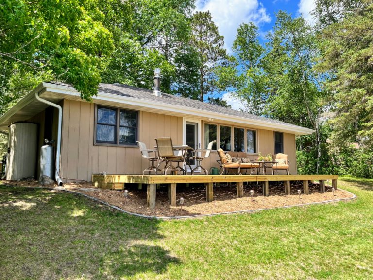 Lakeside deck with seating area and table to enjoy the panoramic lake view